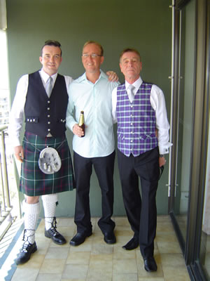 Colin in a kilt next to the groom, John and his dad John