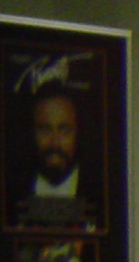 A blown up photo of Pavarotti that was taken in the background of a photo of Laura an me